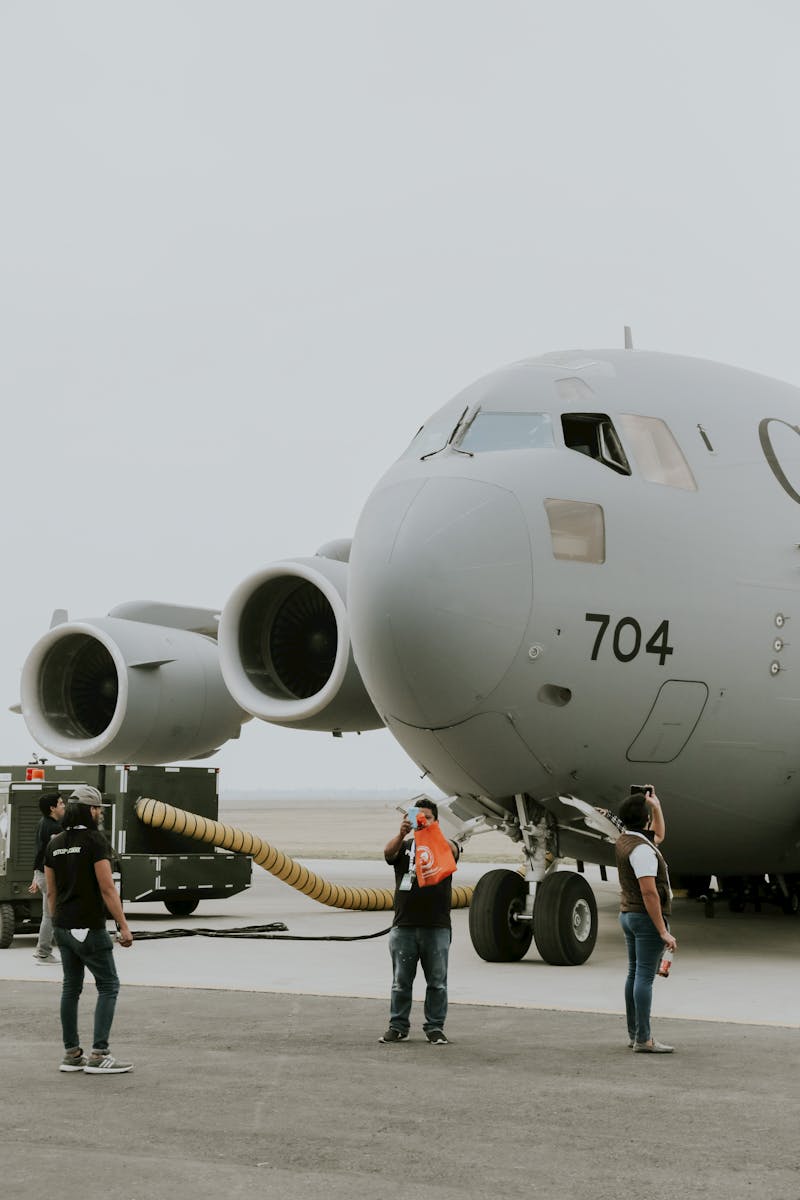 C-17 Globemaster with personnel on the tarmac ready for flight operations.